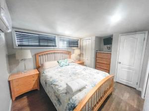 a bedroom with a bed with a wooden bed frame and a table at Magnolia Creek Haus on River Road in New Braunfels