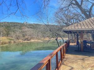 a deck with a view of a lake at Magnolia Creek Haus on River Road in New Braunfels
