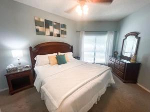 a bedroom with a large bed and a mirror at Our Happy Place in New Braunfels +11 photos