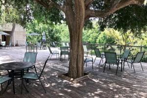 a group of tables and chairs next to a tree at Our Happy Place in New Braunfels