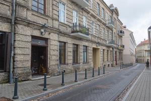 a cobblestone street in front of a building at Modern Vilnius Old Town apartment with free parking in Vilnius