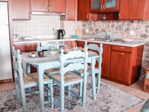 a kitchen with a sink and a table with chairs at Αντίρρινο - Guest house in Arachova