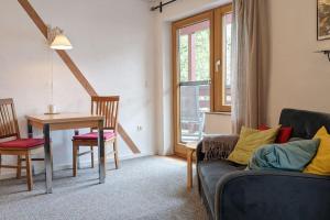 - un salon avec une table et un canapé dans l'établissement Ferienwohnung in ruhiger Lage direkt am Wald, à Heidenheim an der Brenz