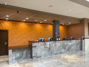 a lobby with a marble counter and chairs at Grand Resort Hotel - Mt Laurel - Philadelphia in Mount Laurel
