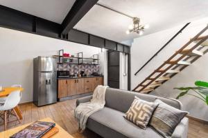 a living room with a couch and a stainless steel refrigerator at +MS +Cómoda Suite +Hércules 4 in Laborcillas