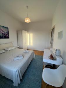 a room with two beds and a table and chairs at Guest House Enny in Dubrovnik