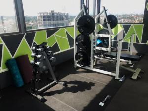 a gym with two weight machines and a window at Premier Executive Apartment - The Ivy, East Legon in Accra