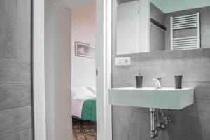 a bathroom with a sink and a mirror at La Chicca B&B Siena in Siena +38 photos