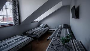 a room with two beds and a window at Villa Marcelina-Buk in Buk