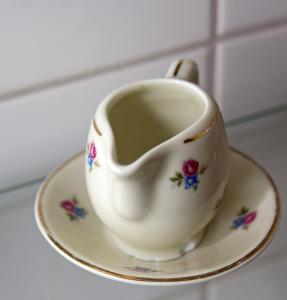 a tea cup sitting on a plate on a counter at Pensionat Ekholmen in Vessigebro