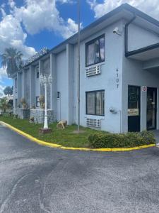 un edificio blanco al costado de una calle en Ambassador Inn, en Kissimmee