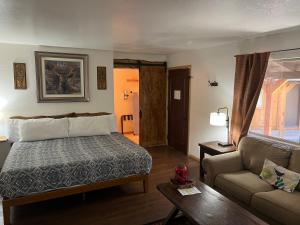 a hotel room with a bed and a couch at TimberLodge Inn in Pinetop-Lakeside