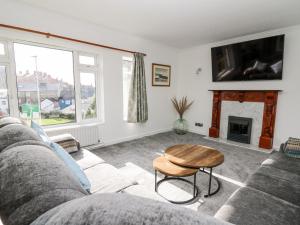 a living room with a couch and a table at Ty Melyn in Aberystwyth