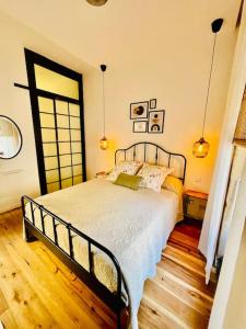 a bedroom with a large bed in a room at 300yr old, self catering, tiny house in Victoria Centre, Gozo in Victoria