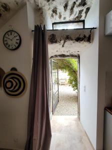 a room with a clock on the wall and a window at The Cosy Home Corbara by 1722 in Corbara
