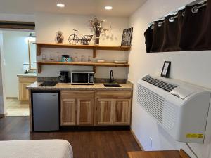 a kitchen with a counter with a microwave and a refrigerator at TimberLodge Inn in Pinetop-Lakeside