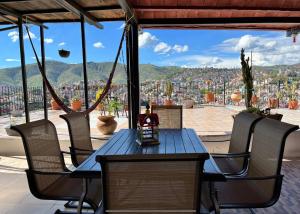 une table et des chaises bleues avec vue sur la ville dans l'établissement HOTEL CASONA DE LAS AVES, à Guanajuato