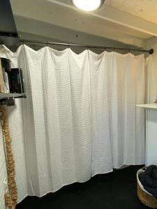 a curtain in a room with white curtains at The Nook in Brookhaven
