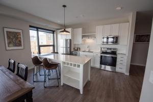 a kitchen with white cabinets and a white counter top at The Berkman in Rochester