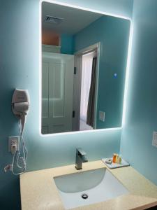 a bathroom with a sink and a mirror at The New View Inn in Tortola Island
