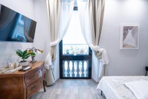 a bedroom with a bed and a dresser and a window at COVO DI LEVANTE in La Spezia