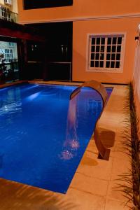 a swimming pool with a water slide in a house at HAUER HOTEL in San Vicente