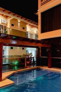 a swimming pool in front of a building at night at HAUER HOTEL in San Vicente