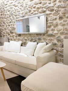 a white couch in a room with a stone wall at Blue Domino Luxury City Villa Patras in Patra
