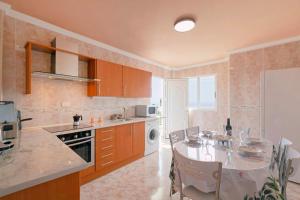 a kitchen with a table and a dining room at clemente house,private pool in Arafo