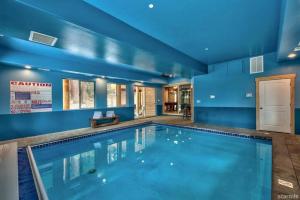 a large swimming pool with a blue wall at Skier's Dream! Mansion Right Next to Heavenly in South Lake Tahoe