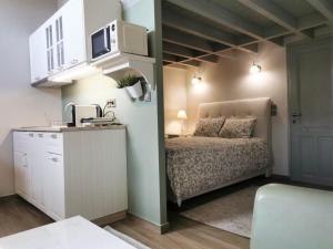 a small bedroom with a bed and a microwave at Casa Carina, Arachova in Arachova