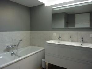 a bathroom with a tub and a sink and a mirror at Maison rénovée dans le bocage Normand avec jacuzzi in Canisy +29 photos