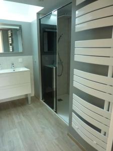 a bathroom with a shower and a sink and a mirror at Maison rénovée dans le bocage Normand avec jacuzzi in Canisy