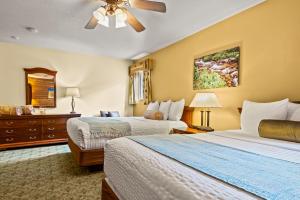 Habitación de hotel con 2 camas y ventilador de techo. en Box Canyon Lodge and Hot Springs en Ouray