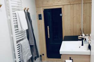 a bathroom with a sink and a blue door at Widokowy apartament Jodłowa Ski&Bike in Szczyrk