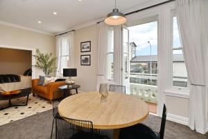 a living room with a table and a couch at Kaiapoi Luxury Accommodation 1 - Bookahome in Kaiapoi