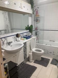 a bathroom with a sink and a toilet and a tub at LIMEHOUSE upon THAMES ROOM IN Great location in London