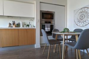 a kitchen with a table and chairs in a kitchen at Lovely 2 Bed Condo in Downtown Toronto in Toronto