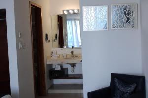a bathroom with a sink and a mirror at Bahia Chac Chi - Adults Only in Isla Mujeres