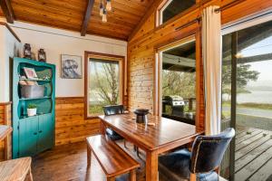 a dining room with a wooden table and chairs at Lake Lytle Lookout in Rockaway Beach