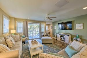 a living room with couches and a flat screen tv at Wildwood Townhome with Patio 1 Block To The Beach! in Wildwood