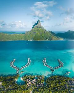 a number of boats floating on top of a body of water at InterContinental Bora Bora & Thalasso Spa, an IHG Hotel in Bora Bora