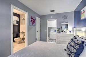 a blue bedroom with a bed and a bathroom at Stuart Apartment with Patio Near St Lucie River! in Stuart +25 photos
