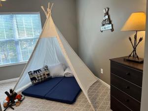 a bed in a room with a teepee at Willow Trace Retreat 5 miles from Dollywood in Sevierville