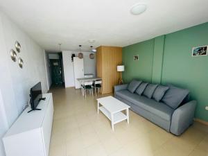 a living room with a couch and a table at Alondras park mialsoma apartment in Arona