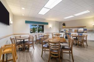 a dining room with wooden tables and chairs at Best Western Saranac Lake in Saranac Lake