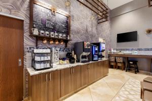 a restaurant with a counter with a coffee station at Best Western Plus St. John's Airport Hotel and Suites in St. John's