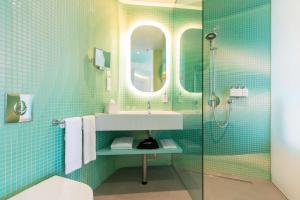 a bathroom with a sink and a shower at Park Inn by Radisson Amsterdam City West in Amsterdam