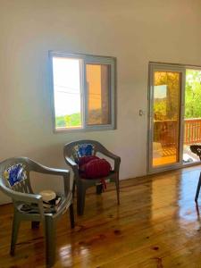 a living room with two chairs and a table at Lila loft- Private one floor bedroom &free parking in Roatan