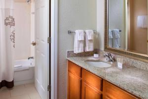 a bathroom with a sink and a mirror at Sonesta ES Suites Birmingham Homewood in Birmingham +16 photos